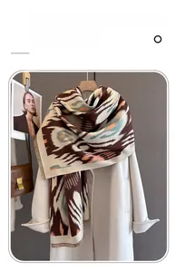 Detailed view of thick imitation cashmere scarf with tassels and geometric print