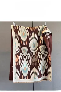 Detailed view of bohemian ikat print scarf with soft fringe trim and ethnic patterns