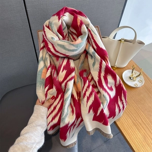 Thick knit ethnic geometric scarf with tassels used as a warm winter shawl for women