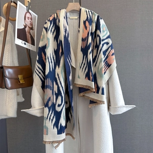 Ethnic pattern cashmere-like scarf with warm geometric print and tassels on white coat