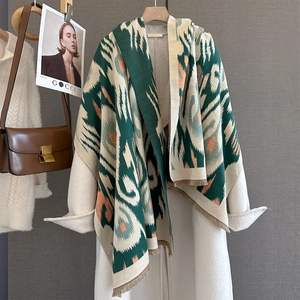 Close-up of geometric pattern scarf with fringe and soft cashmere-like texture