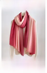 Detailed view of pink gradient cashmere-like scarf featuring soft fringe and thick texture