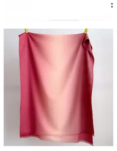 Detailed view of red gradient cashmere-like scarf with soft frayed edges and texture