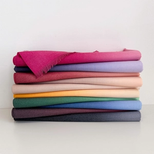 Detail shot of multi-colored pashmina scarves with twill texture and fringe tassels