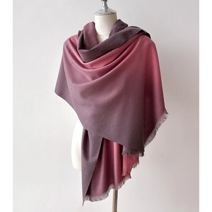 Detail of gradient pink to purple cashmere scarf with soft fringes and fine texture