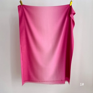 Close-up of pink gradient scarf showing soft fringe details and cashmere-like texture