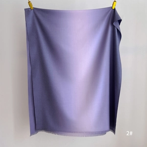 Detail of purple gradient scarf featuring soft cashmere texture and fine fringe hem