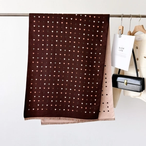 Close-up of double-sided heart pattern scarf with tassels and soft cashmere-like texture