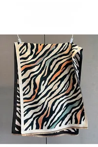 Detail of tiger pattern scarf showing fine printing technology and soft fringes