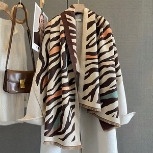 Imitation cashmere scarf with irregular zebra stripes and tassels on a white coat