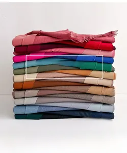 Detailed shot of multi-color cashmere-like scarves showing soft texture and fringe edges