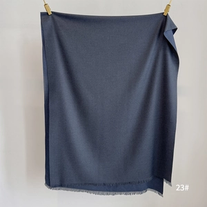 Detail of soft cashmere-like scarf showing 23# dark fabric texture and fringe edges