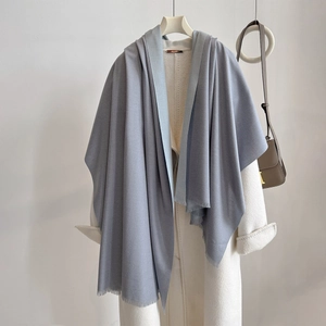 Detail of blue-grey double-sided cashmere shawl with fine fringes and soft texture