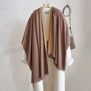 Detail of cashmere-feel scarf with fringe edges and brown two-tone splicing design
