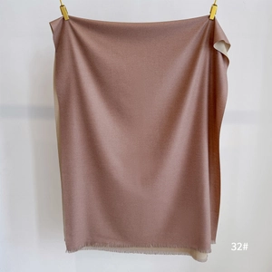 Detailed texture of rose pink double-sided cashmere scarf with soft tassels and fringe
