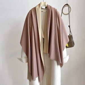 Close-up of pink and beige cashmere-like double-sided scarf with fine fringe detail