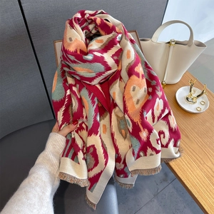 Close-up of geometric heart print scarf with decorative tassels and ethnic pattern