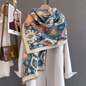 Detailed close-up of Bohemian jacquard scarf with ethnic patterns and fringe tassels