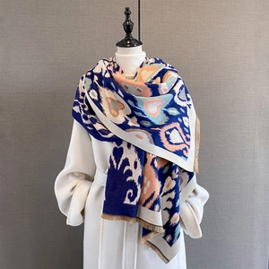 Macro detail of the ethnic geometric pattern and tassel trim on this thick winter shawl
