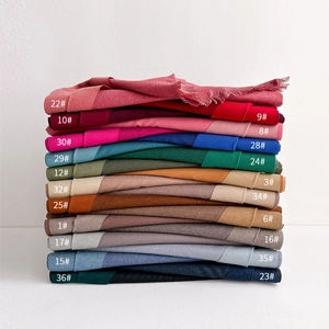 Pile of cashmere-feel solid scarves in 21 colors with delicate tassels for autumn