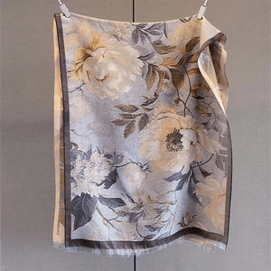 Dettaglio macro del motivo jacquard floreale ed eleganti frange su una grande sciarpa