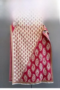 Detailed view of the paisley pattern and soft fringe edges on a thick winter shawl