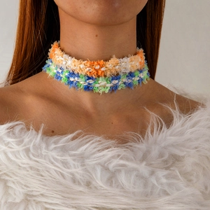 Detail of colorful lace woven chokers with fringe tassels and gold thread accents
