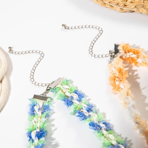 Close-up of woven lace chokers with bohemian textures and adjustable metal chains