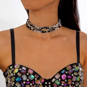 Close-up of vintage tweed lace choker with a central gold chain on woman neck
