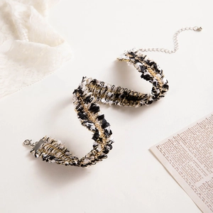 Macro detail of tricolor tweed woven choker necklace with adjustable metal lobster clasp