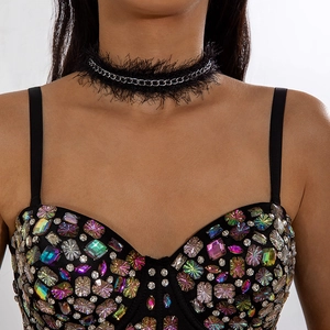 Close-up of black velvet choker with silver ring and colorful rhinestone camisole top