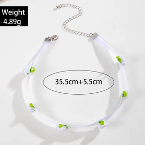 Detailed view of white lace choker featuring handmade silk flowers and green leaves