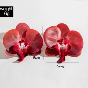 Close-up of red orchid earrings with realistic petal texture and size marking