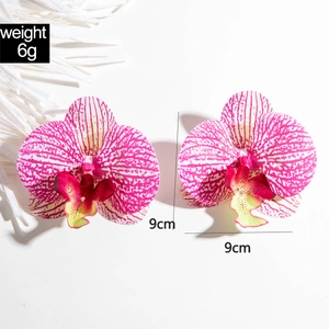 Detail shot of 9cm rose-spotted 3D orchid earring showing size and 6g weight specs