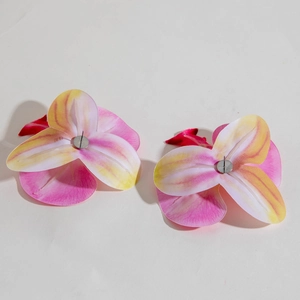 Close-up of orchid earrings with realistic pink-yellow gradient fabric petals