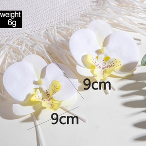 Detailed view of 9cm white orchid flower earrings showing 6g weight and floral texture