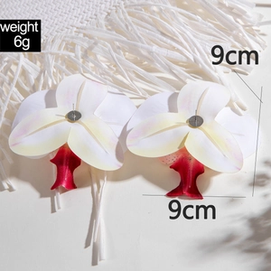 Macro detail of 3D orchid flower earrings showing white to red gradient petals and 9cm size