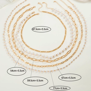 Detail of five-layer gold alloy necklace set with pearls and paperclip chain lengths