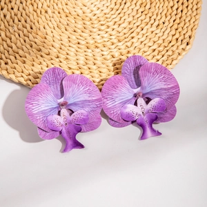 Macro detail of 3D purple orchid earrings showing realistic petal texture and gradient