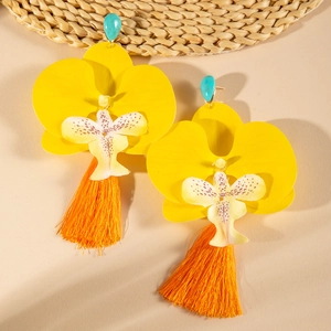 Detail of colorful orchid earrings featuring yellow petals and bright orange silk tassels