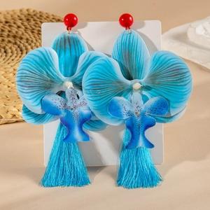 Detailed close-up of oversized blue orchid tassel earrings with bohemian fabric floral design