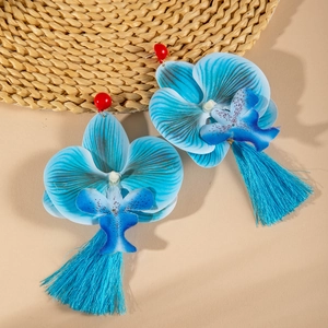 Close-up of blue orchid earrings with fabric petals and long matching tassels