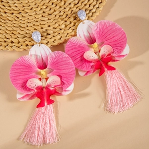 Detailed view of layered pink orchid earrings with long silk tassels and marble stud