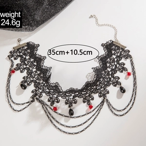 Gothic lace choker with red crystal pendants and layered black chains on a white background