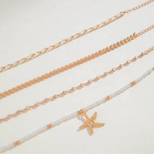 8-piece Bohemian anklet set with golden starfish charms and white seed bead chains