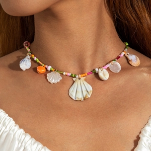 Detail of bohemian summer necklace with colorful beads and white seashell shell pendants
