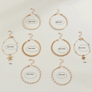 8-piece bohemian anklet set with starfish shell pendants and gold-tone leaf chains