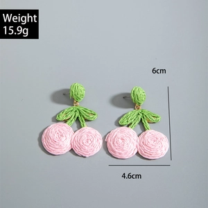 Detail view of handmade pink woven cherry earrings with dimensions 6cm by 4.6cm
