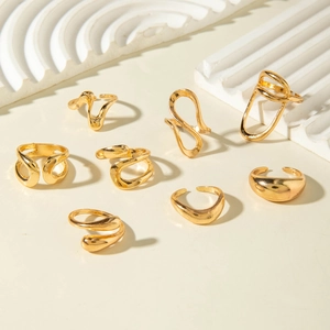 Macro view of eight irregular gold hollow rings with smooth polished metallic textures