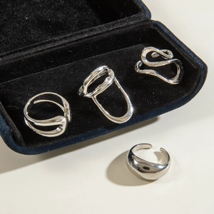Set of four irregular hollow silver open rings with minimalist liquid metal design